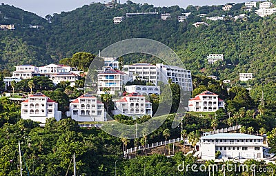 Luxury White Stucco Condos on Green Tropical Hillside Stock Photo