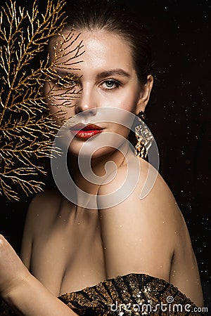 Luxury Woman Portrait with Gold Jewelry. Mystery Girl hiding Face. Glitter Make up. Elegant Lady over Black Background Stock Photo