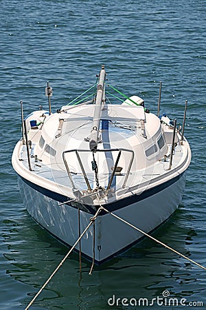 Luxury Yacht head on symmetrical tied to pier in blue waters Stock Photo