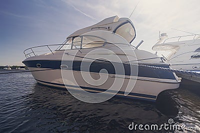 Luxury yachts moored at the pier illuminated by the sun Stock Photo