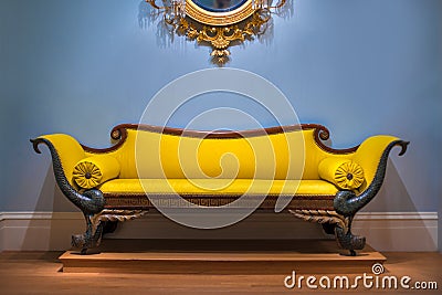 Luxury yellow sofa in front of the blue wall Stock Photo