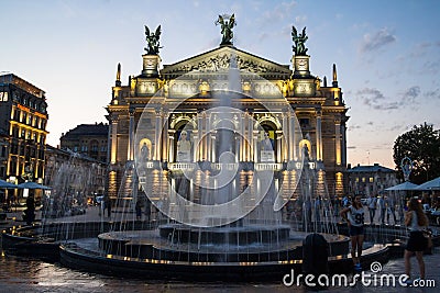 LVIV, UKRAINE - AUGUST 18, 2015: Young girls taking selfies in front of Lviv Opera at sunset. Editorial Stock Photo