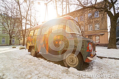 LVIV, UKRAINE - Feb 14, 2017: Old vintage retro abandoned car painted graffiti artists in the hippy style is broken on one of the Editorial Stock Photo