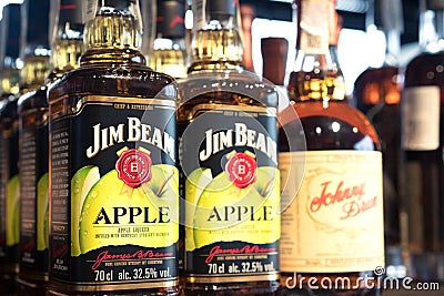 Lviv, Ukraine - February 20, 2022 : Bad Boy liquor store, bottles with Jim Beam apple liqueur infused with Kentucky bourbon Editorial Stock Photo