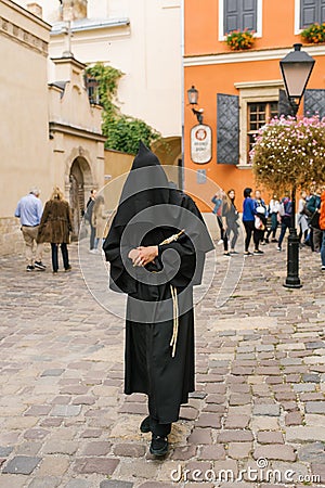 Lviv, Ukraine. Guide in monk clothes on an animated tour for tourists Editorial Stock Photo