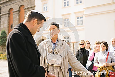 Lviv, Ukraine. Guides in the costume of a beggar and a Jew on an animated tour in a historic city Editorial Stock Photo