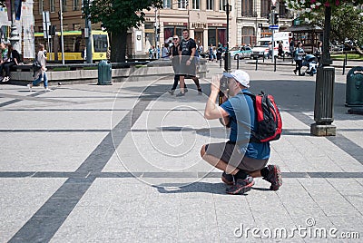 Lviv, Ukraine: Male photographer makes a photo for tourists on the streets Editorial Stock Photo