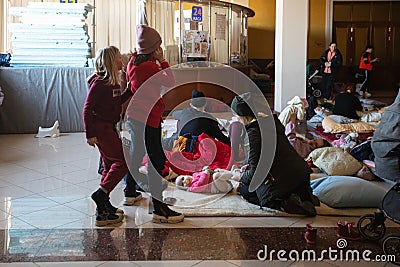 Ukrainian refugees on Lviv railway station during russian war. Refugee kids in waiting hall Editorial Stock Photo