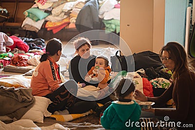 Ukrainian refugees on Lviv railway station during russian war. Refugee kids in waiting hall Editorial Stock Photo