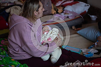 Ukrainian refugees on Lviv railway station during russian war. Refugee kids in waiting hall Editorial Stock Photo