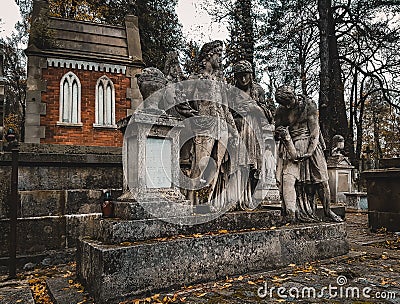 Lviv / Ukraine - November 2019: A set of sculptures at the old crypt at Lychakiv cemetery. Beautiful tonbstone statues in serene Stock Photo