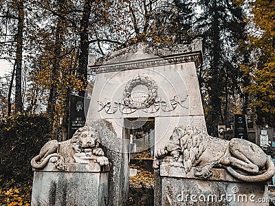 Lviv / Ukraine - November 2019: Tombstone and lion sculptures in a crypt outdoor at Lychakiv cemetery. Famous old graveyard in Stock Photo