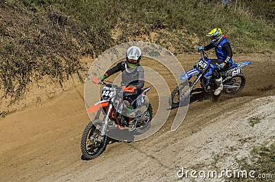 LVIV, UKRAINE - OCTOBER 2021: Athletes motorcycle racers compete in motocross competition on the race track Editorial Stock Photo