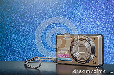 Lviv Ukraine 05.15.2020 old digital camera from 2000 year advertising poster studio lighting on festive blue bokeh background view Editorial Stock Photo