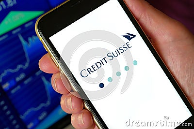 Lviv, Ukraine - 03 11 2023: Person holding mobile phone with logo of financial company Credit Suisse Group AG on screen Editorial Stock Photo