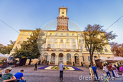 LVIV, UKRAINE - SEPTEMBER 12, 2016: Lviv City and Lviv Old Town With People. Sunset Light and Lviv City Hall Editorial Stock Photo