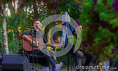 Lviv, Ukraine - 09,26,2021 - street musician male person with guitar outdoor park land space, young culture Editorial Stock Photo