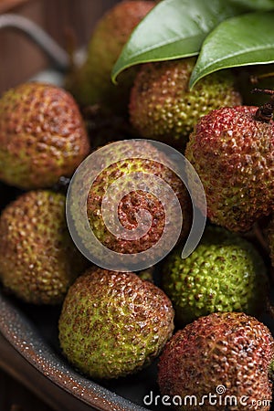 Lychees on a dark wooden table in the kitchen,Litchi chinensis Sonn,lizhi,close up Stock Photo