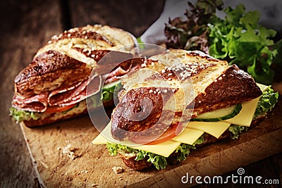 Lye bread rolls with cheese and salami Stock Photo