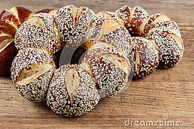 Lye kringle with sesame on a wooden board Stock Photo