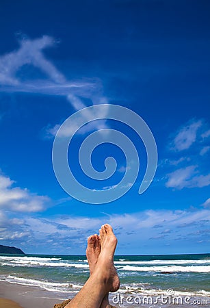 Lying on the beach with dollar symbol Stock Photo