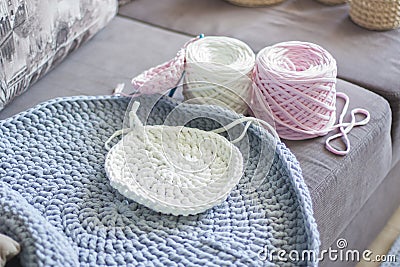 Lying on the couch skeins of yarn and knitted products Stock Photo