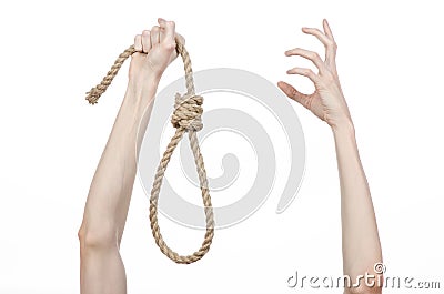 Lynching and suicide theme: man's hand holding a loop of rope for hanging on white isolated background Stock Photo