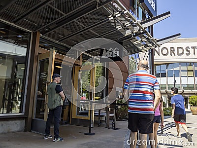 Lynnwood, WA USA - circa July 2021: View of people lining up outside of an REI store at the Alderwood Mall Editorial Stock Photo