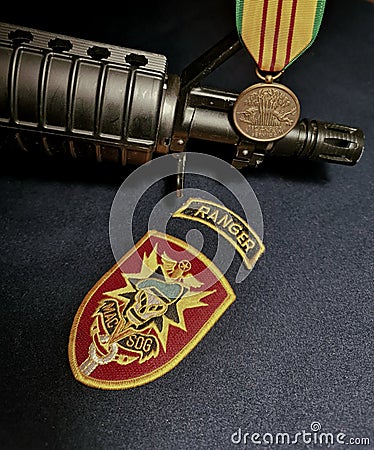 M4 carbine, Vietnam Service Medal and MacVSog emblem Editorial Stock Photo