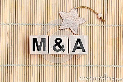 M and A - Merger and Acquisition - word wooden cubes Stock Photo