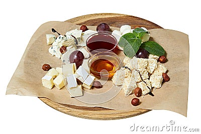 Maasdam, brie, camembert, roquefort cheeses on cheese board served with grapes Stock Photo