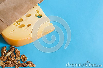 Maasdam cheese with wallnuts on a blue with copy space Stock Photo