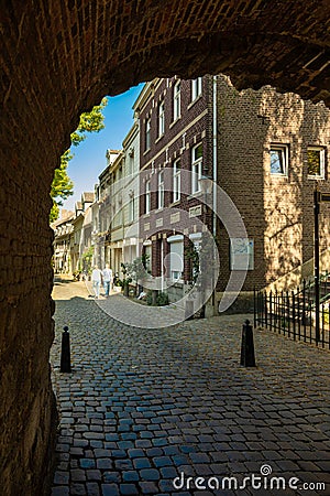 Onze lieve vrouwewal and Helpoort in downtown Maastricht This street and rampart in the Jekerkwartier runs along the park in Maast Editorial Stock Photo