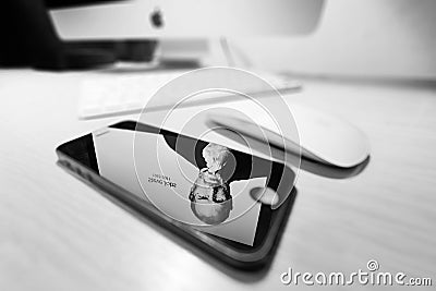 Mac with reflection of Steve Jobs in a iPhone 5 Editorial Stock Photo