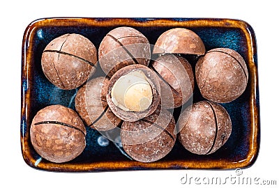 Macadamia nuts with peeled seed in bowl cutout Stock Photo