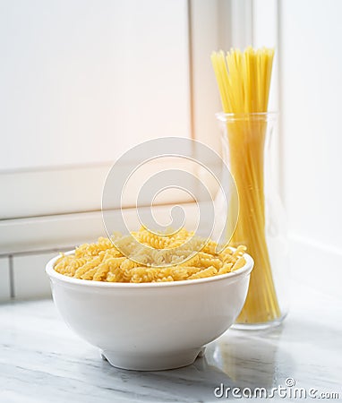 Macaroni in bowl with spaghetti sticks nooddle Stock Photo