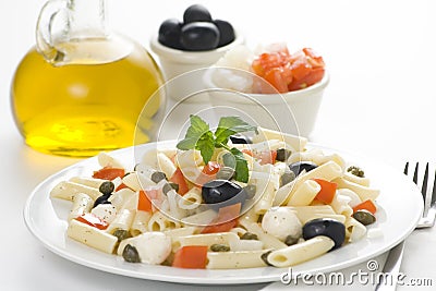 Macaroni mozzarella olives capers tomatoes salad Stock Photo