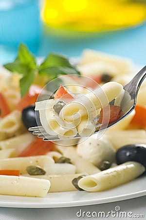 Macaroni mozzarella olives capers tomatoes salad Stock Photo