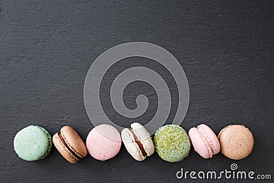 Macarons cake, top view flat lay, macaroon on black background Stock Photo