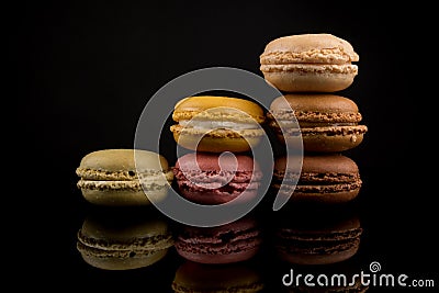 Macarons, Colorful Stack of Macarons, isolated on black background with reflections, copy space, multiple colors, centered Stock Photo