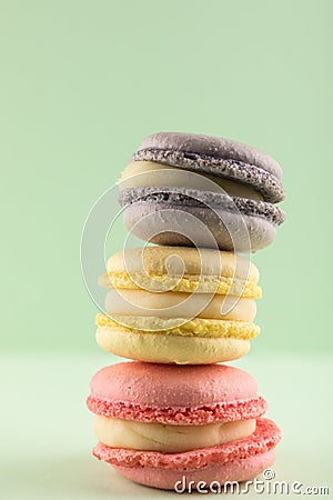 Macarons Pastel colors, Purple, Yellow and pink on Green background Stock Photo