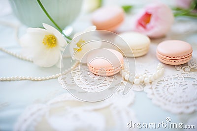 macarons and pearls on a lace tablecloth for elegance Stock Photo