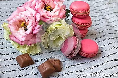 Macaroons with flowers on paper, with an inscription Stock Photo