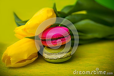 Macaroons food with tulips yellow background for valentines mother woman day easter with love Stock Photo