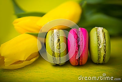 Macaroons food with tulips yellow background for valentines mother woman day easter with love Stock Photo