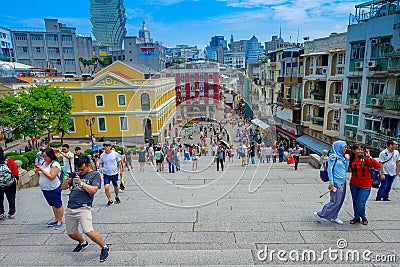 MACAU, CHINA- MAY 11, 2017: An unidentified people taking pictures about the beautiful city of Macau, behind the Editorial Stock Photo