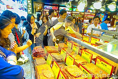 MACAU, CHINA- MAY 11, 2017: An unidentified people watching a delicious chinese food, dried meat slice Editorial Stock Photo