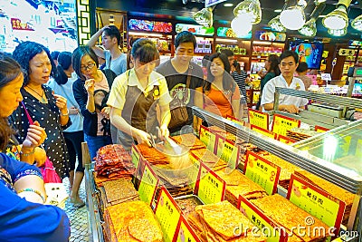 MACAU, CHINA- MAY 11, 2017: An unidentified people watching a delicious chinese food, dried meat slice Editorial Stock Photo