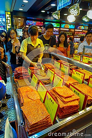 MACAU, CHINA- MAY 11, 2017: An unidentified people watching a delicious chinese food, dried meat slice Editorial Stock Photo