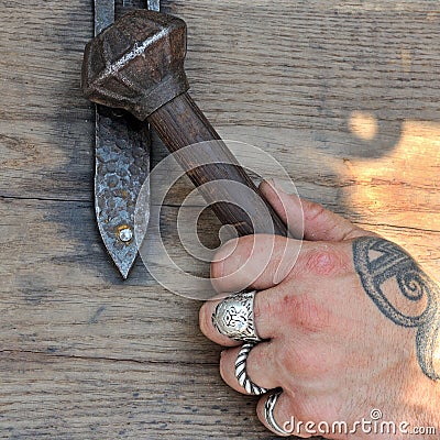 Mace, ancient Viking weapons, in the brutal hand of a man`s hand Stock Photo